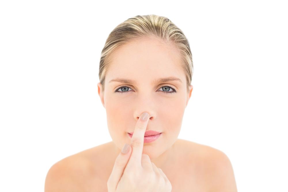 woman pointing to dry skin around nose