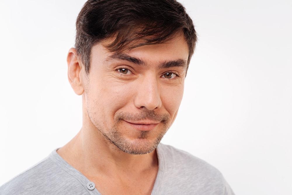 man contemplating trying one of many face masks for men