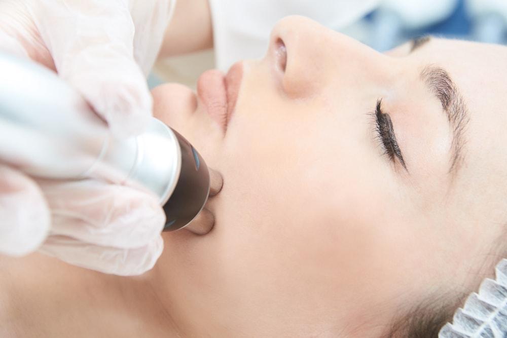 woman undergoing microcurrent facial treatment