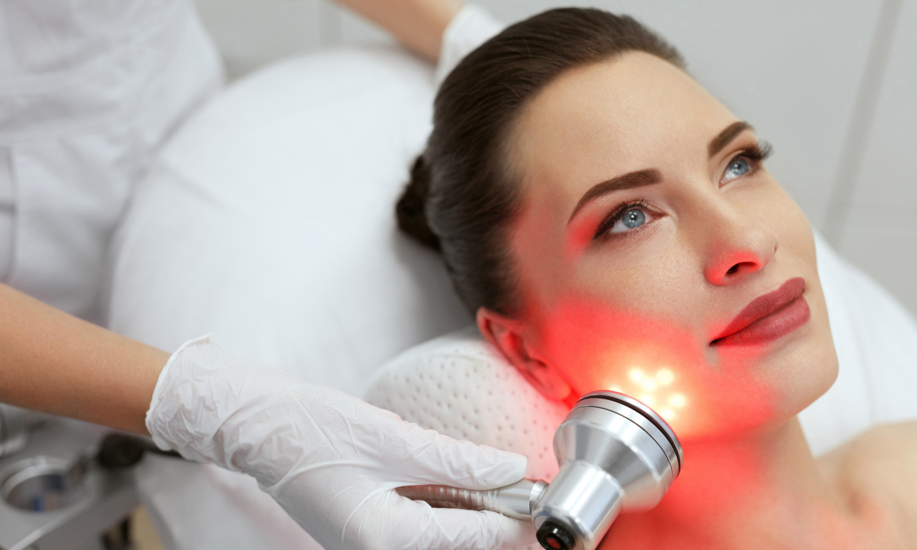 Woman undergoing red light therapy treatment at dermatologist