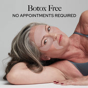 woman laying down with silicone patches on face