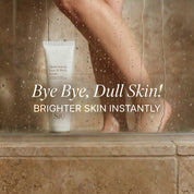 SIO Beauty Multivitamin Face & Body Scrub tube with a woman's legs in the background, suggesting a shower setting.