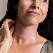 SIO Beauty Neck Hydroseal Patch applied to a woman's neck to hydrate skin and reduce fine lines.